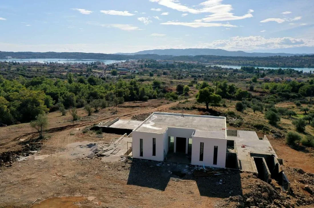 Real aerial photo of the residence under construction above the Porto Heli lagoon, Ververonta